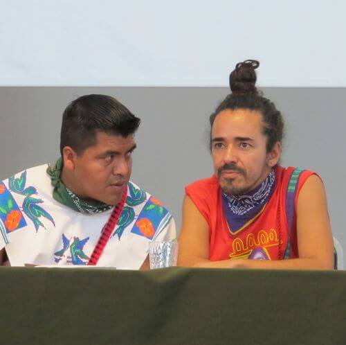 Wixarika leader Santos de la Cruz consults with Ruben Albarran of Café Tacuba in a May 2012 press conference right before Wirikuta Fest.