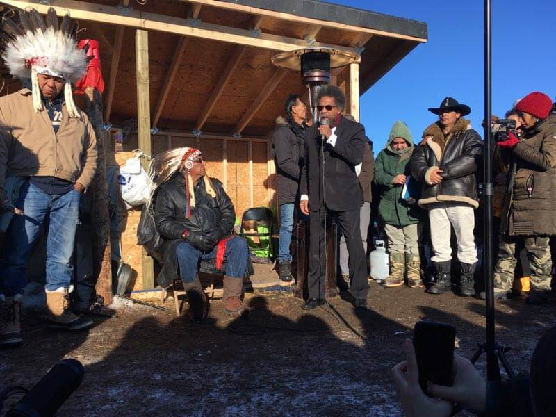 Cornel West addresses the interfaith gathering at Oceti Sakowin Camp as Chief Arvol Looking Horse looks on. Photo: Nelson Denman