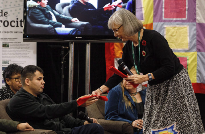 Chief Commissioner Marion Buller gives Paul Tuccaro an eagle feather